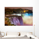 Niagara Falls lit at night by colorful lights 