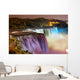 Niagara Falls lit at night by colorful lights 