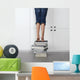 teenage girl standing on top of a stack of books Wall Mural