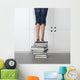 teenage girl standing on top of a stack of books Wall Mural