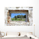 spanish countryside seen through hole in wall of ruins Wall Mural