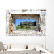 spanish countryside seen through hole in wall of ruins Wall Mural