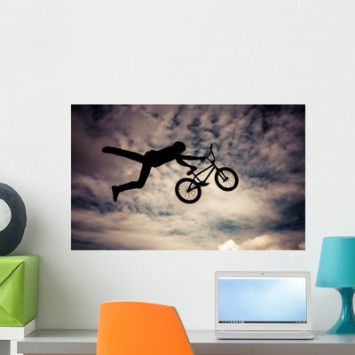 Silhouette Man Doing Jump Wall Decal shown on a wall