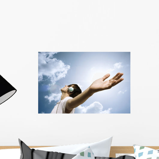 teen with headphones enjoy the music,focus point on hand Wall Mural