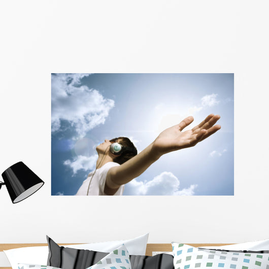 teen with headphones enjoy the music,focus point on hand Wall Mural