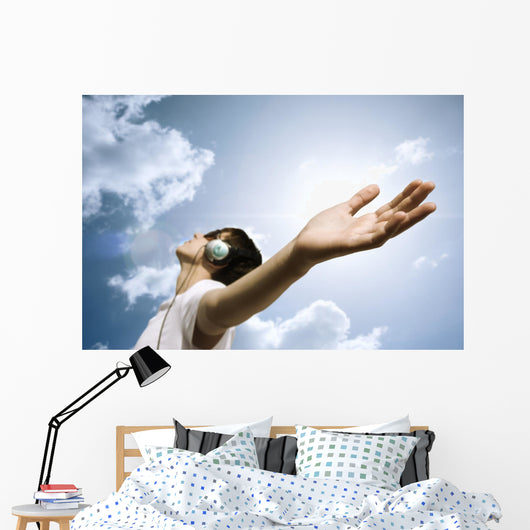 teen with headphones enjoy the music,focus point on hand Wall Mural