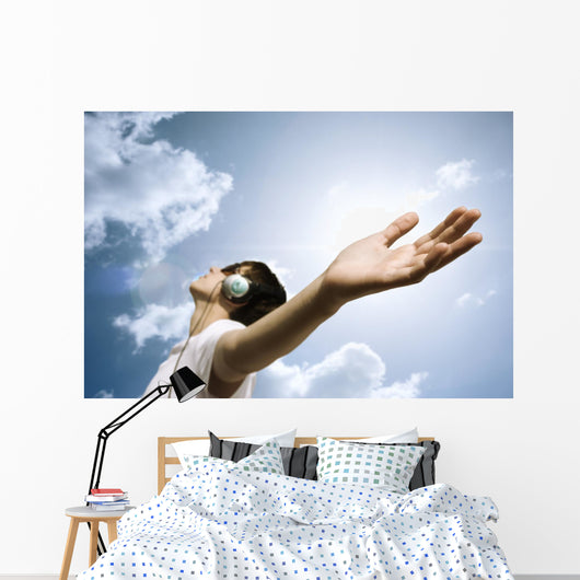 teen with headphones enjoy the music,focus point on hand Wall Mural