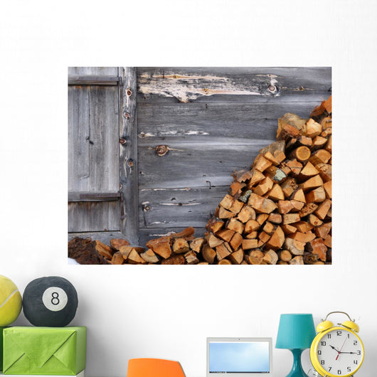 Firewood to the wooden wall of a hut 