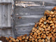 Firewood to the wooden wall of a hut 
