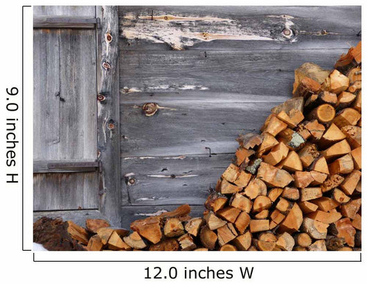 Firewood to the wooden wall of a hut 