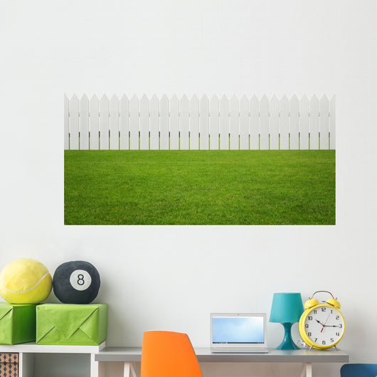 Front or back yard, white wooden fence on the grass Wall Mural