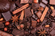 Background from slices of chocolate, coffee, nuts and spices Wall Mural