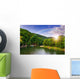 river flows by rocky shore near the autumn mountain forest Wall Mural
