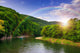 river flows by rocky shore near the autumn mountain forest Wall Mural