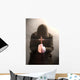 A monk praying with a rosary and crucifix in his hand. Wall Mural