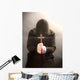 A monk praying with a rosary and crucifix in his hand. Wall Mural