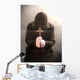 A monk praying with a rosary and crucifix in his hand. Wall Mural