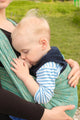Breastfeeding in baby sling outdoors 