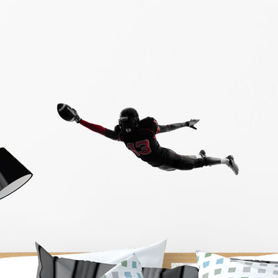 Football Player Scoring Touchdown Wall Decal shown on a wall