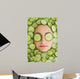 Beautiful woman with facial mask of cucumber slices on face Wall Mural