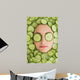 Beautiful woman with facial mask of cucumber slices on face Wall Mural