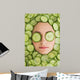 Beautiful woman with facial mask of cucumber slices on face Wall Mural