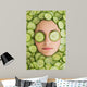 Beautiful woman with facial mask of cucumber slices on face Wall Mural