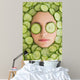 Beautiful woman with facial mask of cucumber slices on face Wall Mural