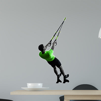 Man Exercising Suspension Training shown on a wall