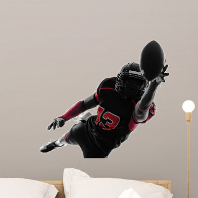 American Football Player Catching shown on a wall