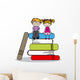 kids sitting on books 