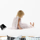 little girl sadly sitting in white dress and angel wings Wall Decal
