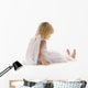 little girl sadly sitting in white dress and angel wings Wall Decal
