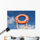 Life buoy ring in man's hands on a background of the sky. Wall Mural