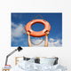 Life buoy ring in man's hands on a background of the sky. Wall Mural