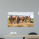 Horses eating at a feed fence 