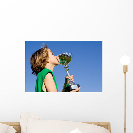 happy successful winner with cup or trophy Wall Mural