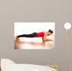 Young woman exercising - doing a plank in a studio 