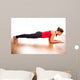 Young woman exercising - doing a plank in a studio 