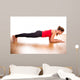 Young woman exercising - doing a plank in a studio 