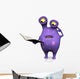 A spotted monster reading book and looking confused. 
