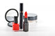 Basic red makeup cosmetics on white background. 