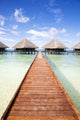 tropical beach: tropical resort and cloudy sky Wall Mural