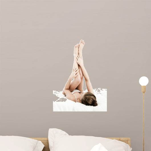 Woman massaging legs lying on white background 