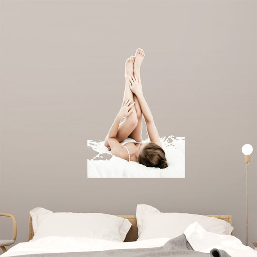 Woman massaging legs lying on white background 