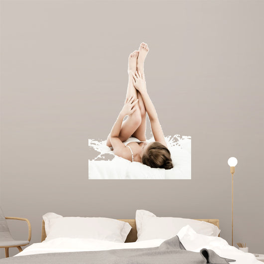 Woman massaging legs lying on white background 