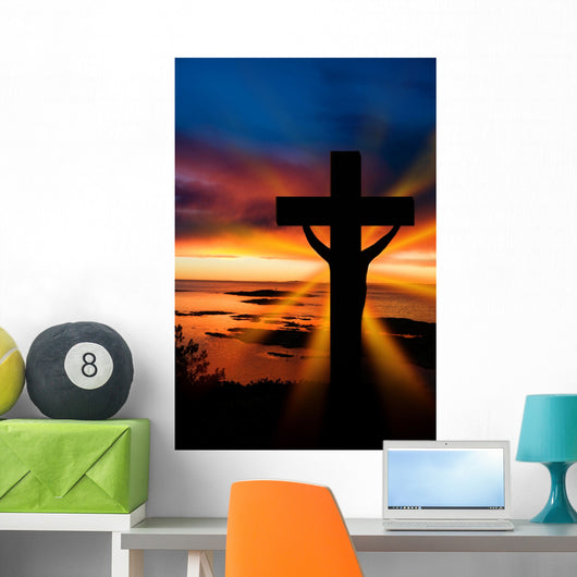 A cross at sundown on the ocean Wall Mural