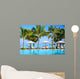 Swimming pool with  umbrellas on beach in Mauritius Wall Mural
