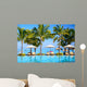 Swimming pool with  umbrellas on beach in Mauritius Wall Mural