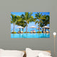 Swimming pool with  umbrellas on beach in Mauritius Wall Mural